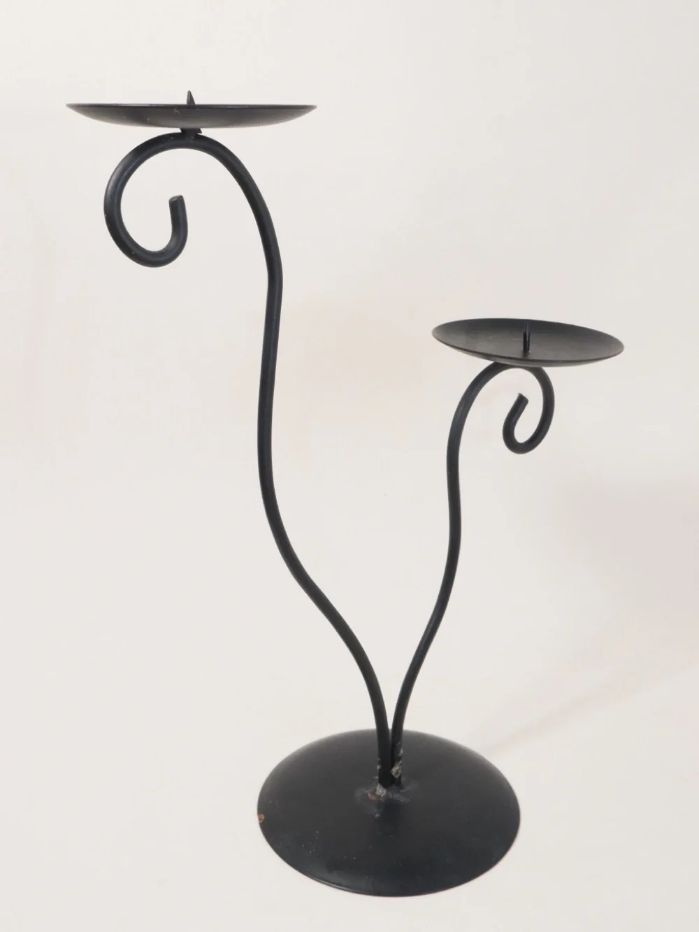 Vintage postmodern black metal double candle holder with a scrollwork design